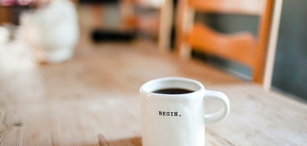 Mug with begin written on it