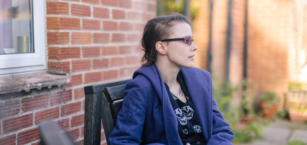 A woman writing in a notebook outside