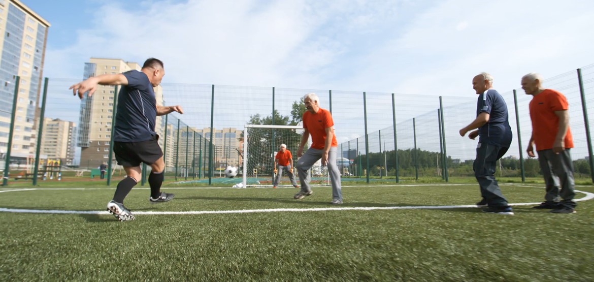 Mid life men playing football