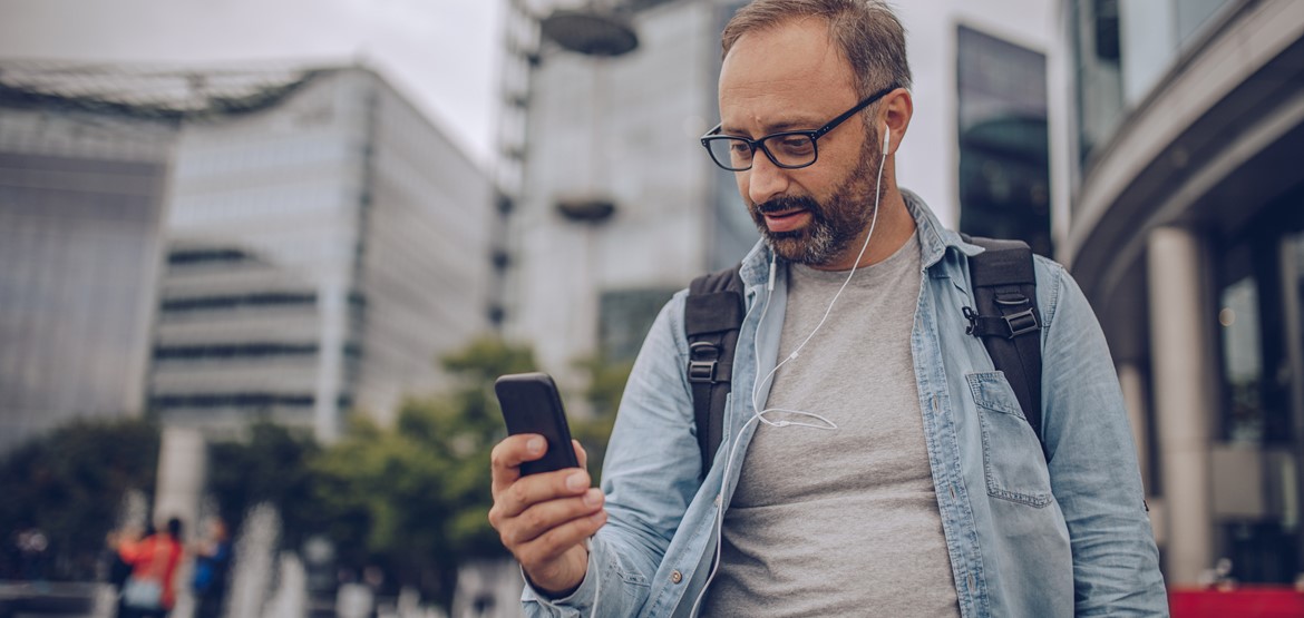 Man walking home and using app