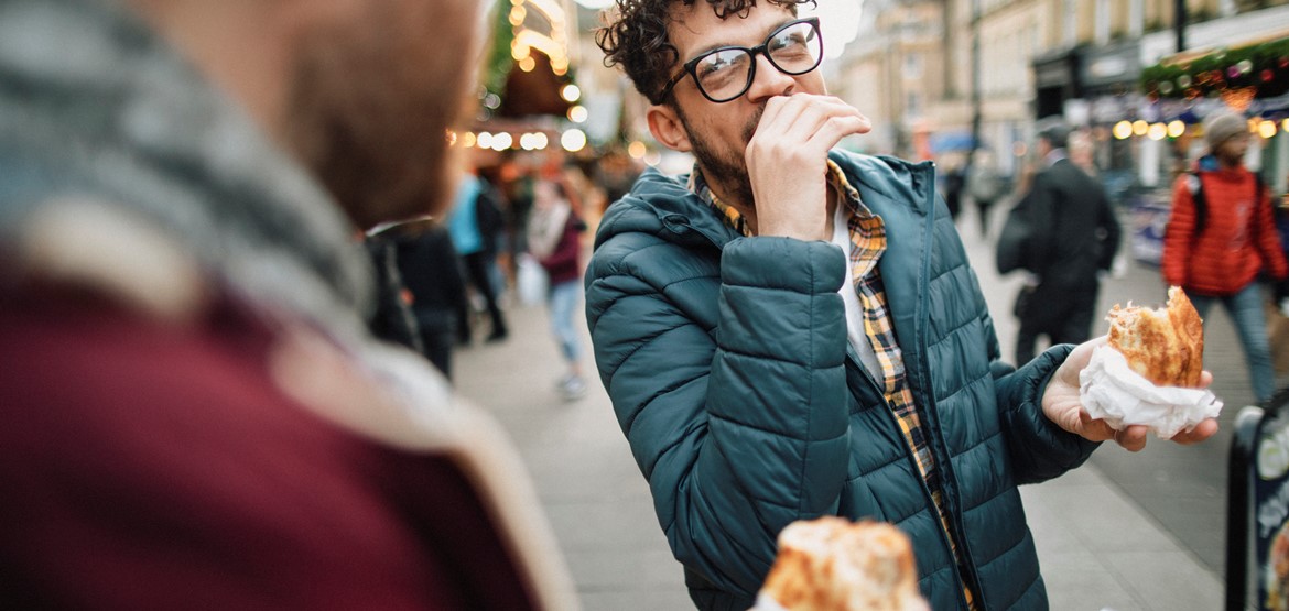 A male couple at an outside food market