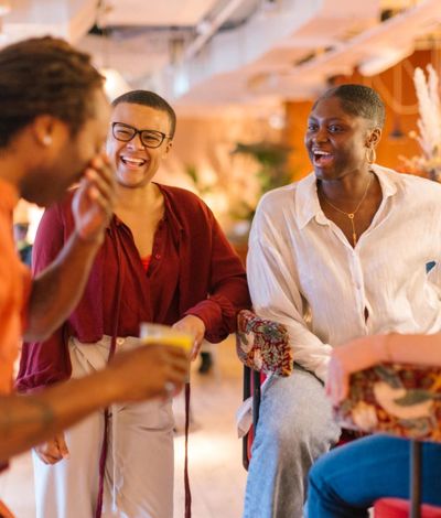 Group of friends in a bar laughing.