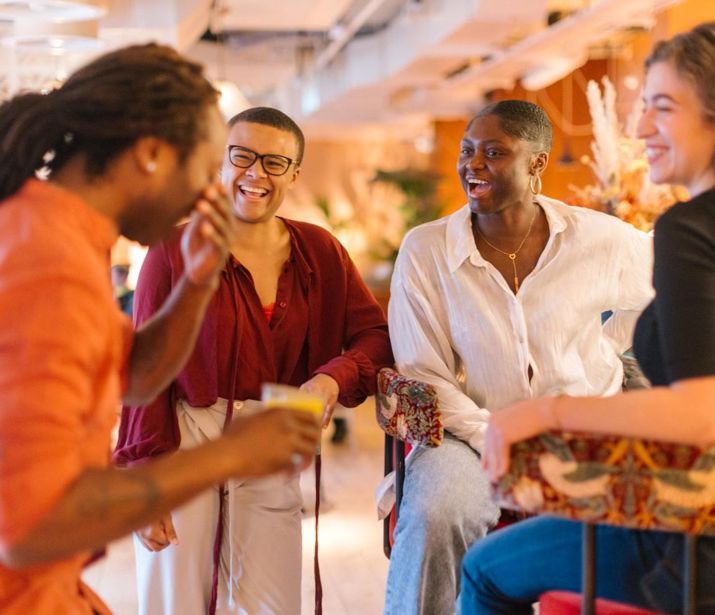 Group of friends in a bar laughing.