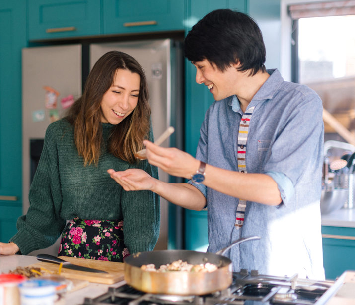 two people cooking at home