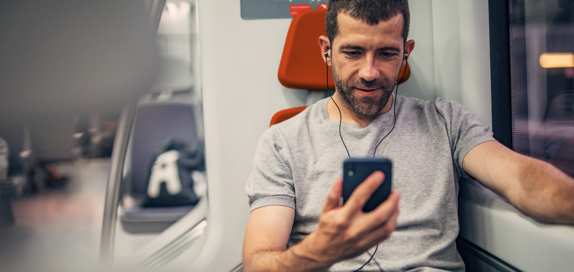 45plus_image-3_man-on-train-looking-at-phone_crop