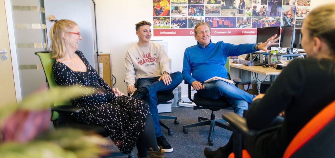 Group sat having a meeting in an office.