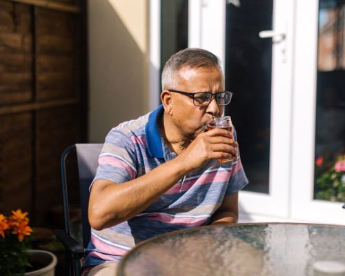 Person Drinking Beer In The Garden At Home Drinking