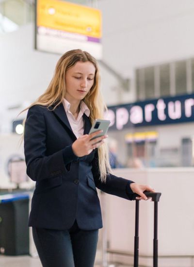 Person in airport checking their phone.