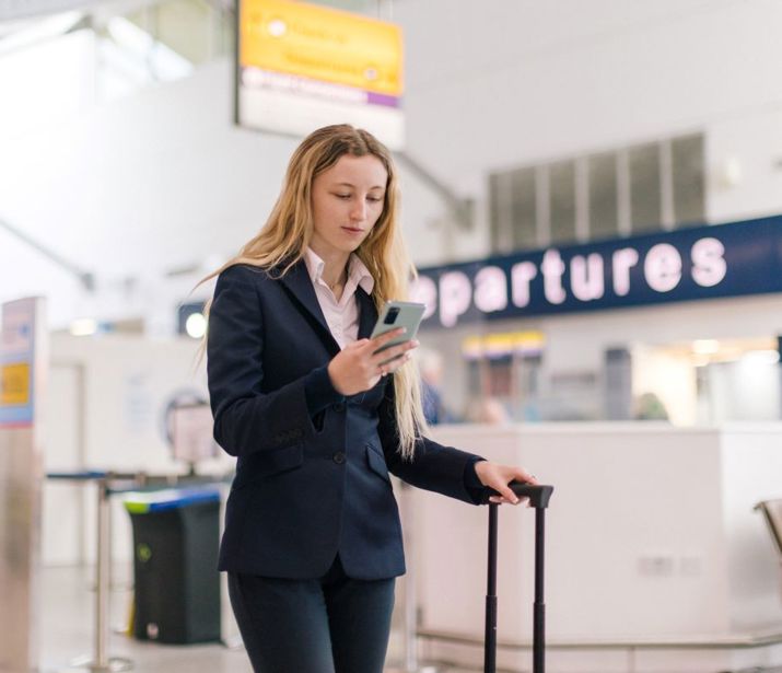 Person in airport checking their phone.