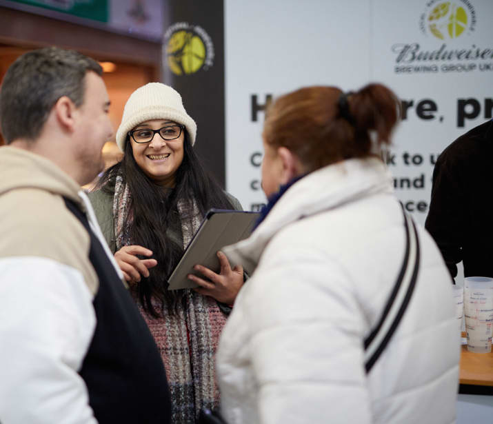 Drinkaware staff member talking to members of the public at a Budweiser stall