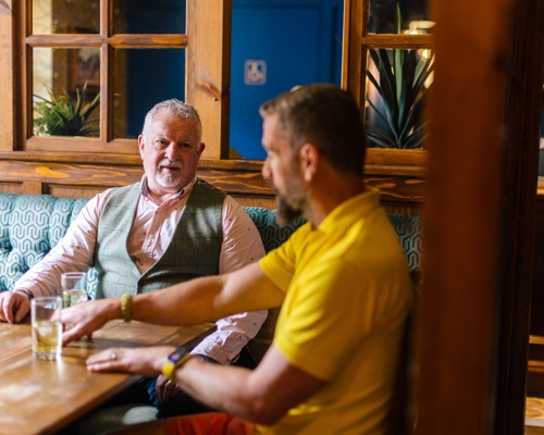 Two men sat having a drink in a pub 