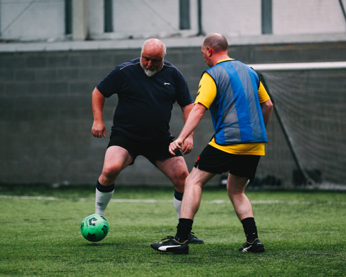 2 men playing walking football