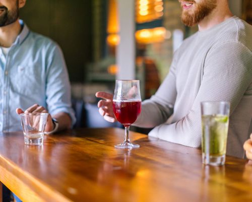 People With Drinks On Table Closeup Pub Settings