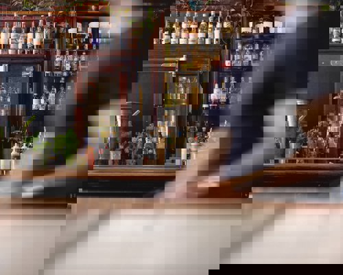 A bar with alcohol bottles