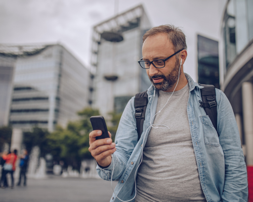 Man walking home and using app